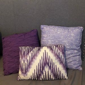 3 purple themed throw pillows